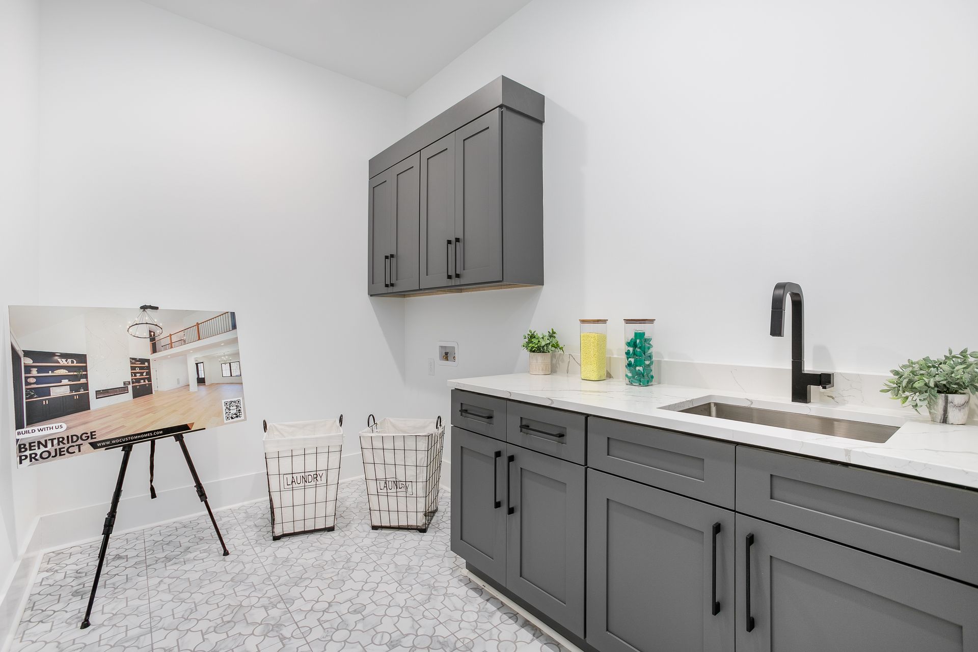 Laundry room cabinetry with gray finishes and functional storage in the Strickland Heights project Summerfield NC