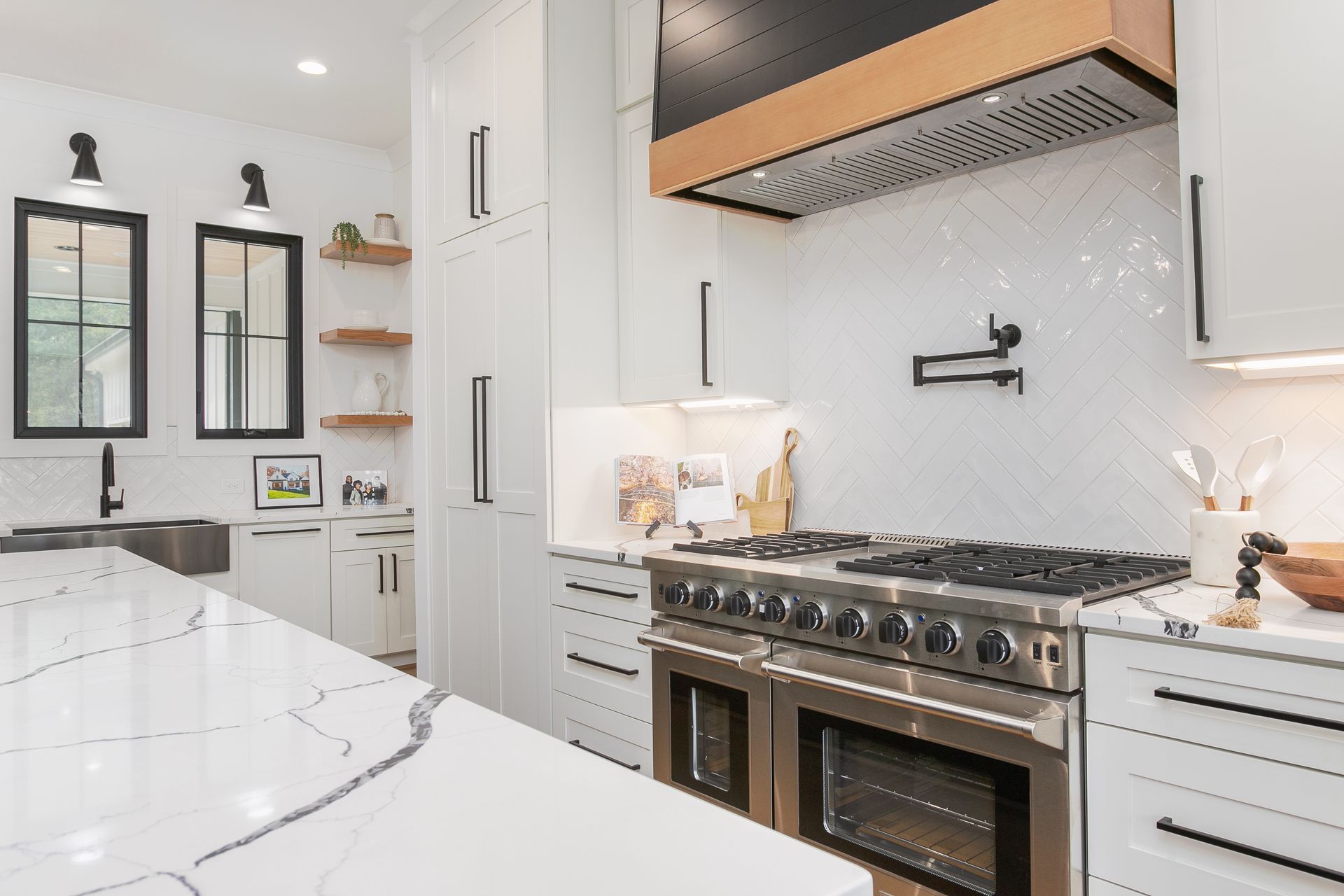 Luxury range area with custom white cabinetry and wood detail in The Hills project Summerfield NC