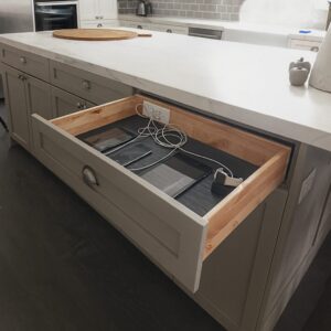 Legacy by Körner Drawer Charging & Power Station with built-in outlets and USB ports, shown open to store and charge devices neatly inside a kitchen drawer.