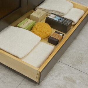 Hidden toe kick drawer in bathroom vanity for extra storage from the Legacy collection.