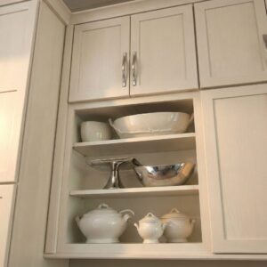 Open wall shelving installed in a modern kitchen providing clean open storage for everyday cooking essentials