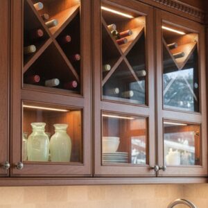 X wine rack insert holding bottles in an organized cabinet layout
