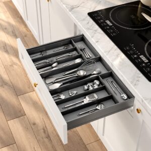 Kitchen utensil drawer organizer with divided compartments for cutlery, cooking tools, and small accessories.