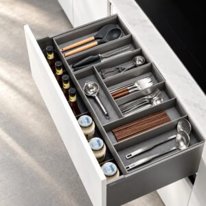 Cutlery and utensil tray with divided compartments organizing flatware, cooking tools, chopsticks, and everyday kitchen accessories.