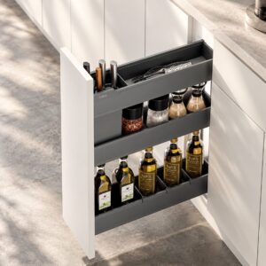 Spice and utensil pull out organizer with tiered storage for bottles, pantry items, and kitchen tools in a narrow base cabinet.