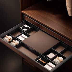 Pull-out accessory organizer drawer with divided compartments in a luxury custom closet
